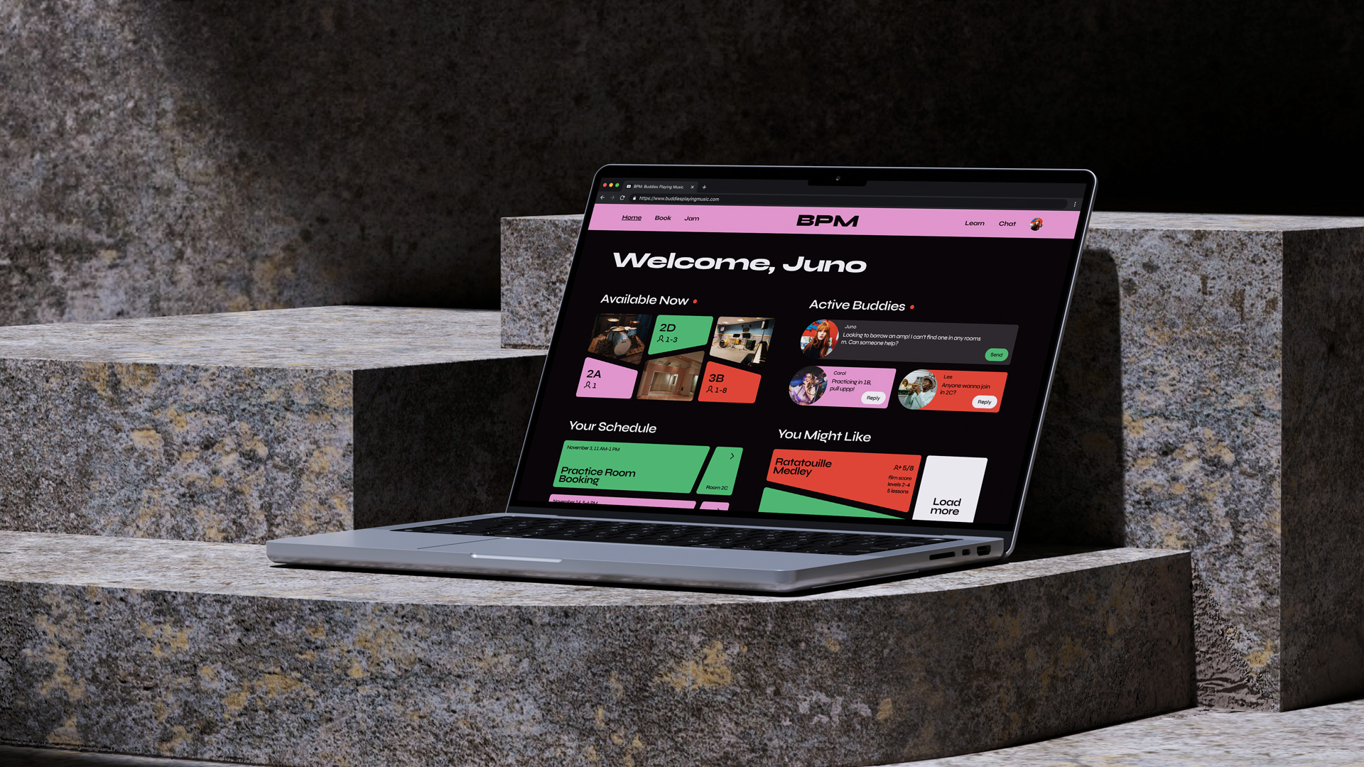 A laptop version of BPM’s home screen set on brightly lit stone steps.