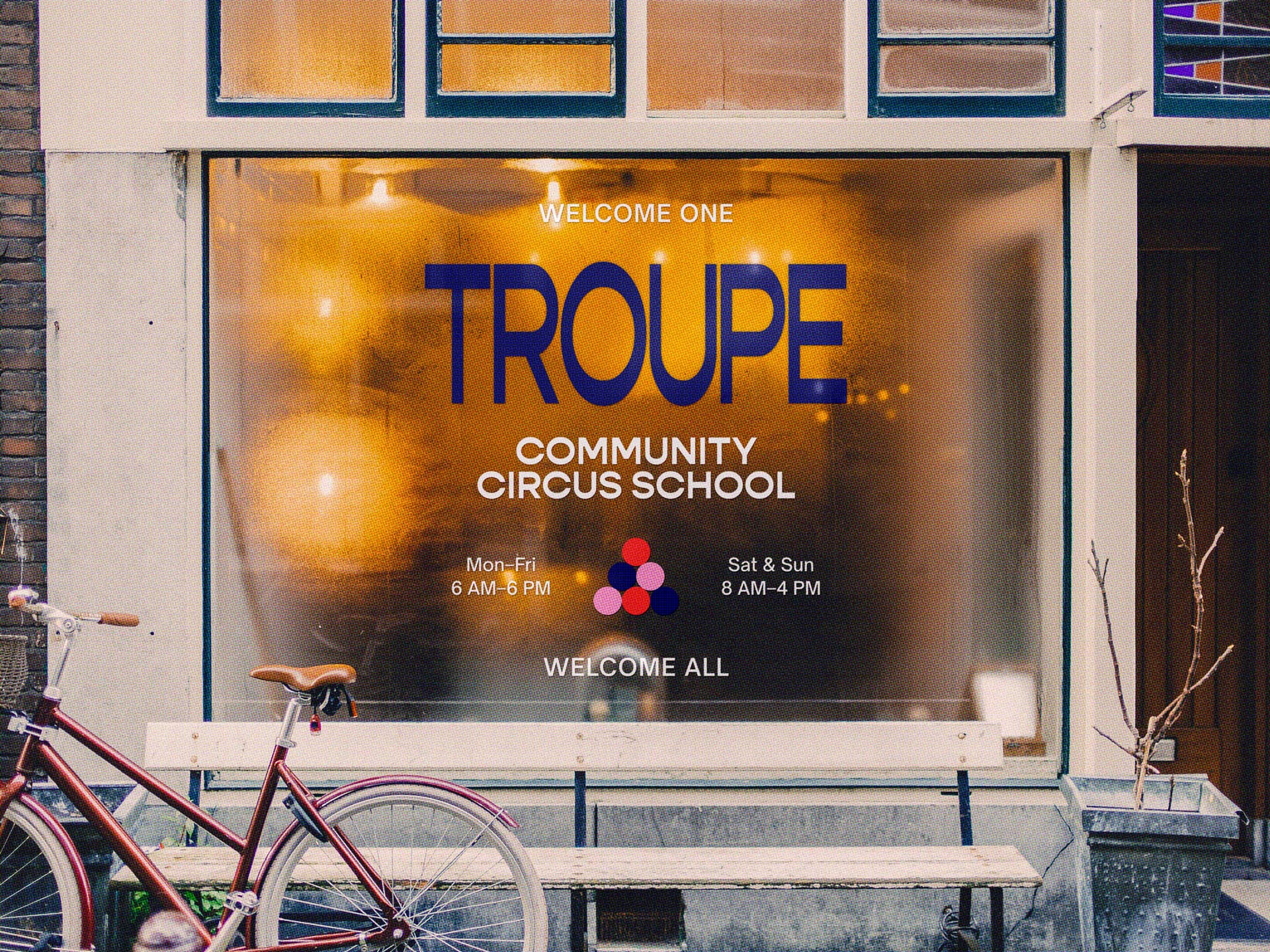 A frosted window at Troupe’s studio entrance welcomes one and all to the community circus school with labelled hours.