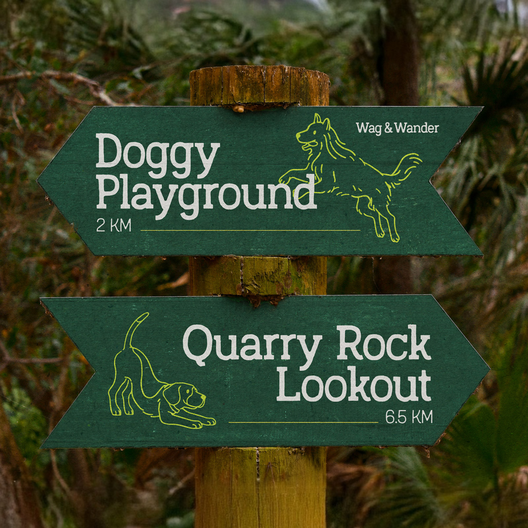 Arrow-shaped wayfinding signs direct to a Wag & Wander doggy playground and Quarry Rock Lookout.