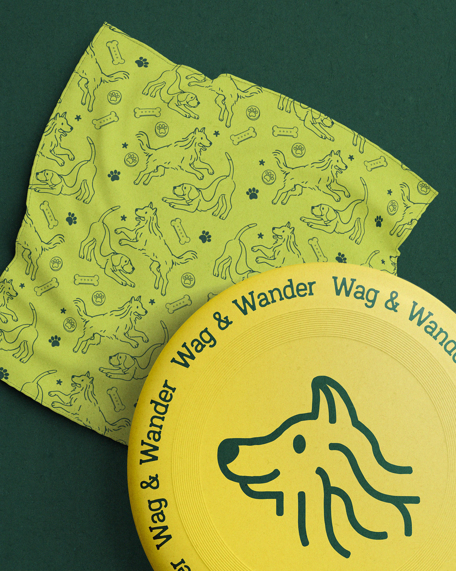 Two pieces of Wag & Wander merchandise: a lime green dog bandana with a Scout and Trek pattern and a yellow frisbee with the brand’s logo.
