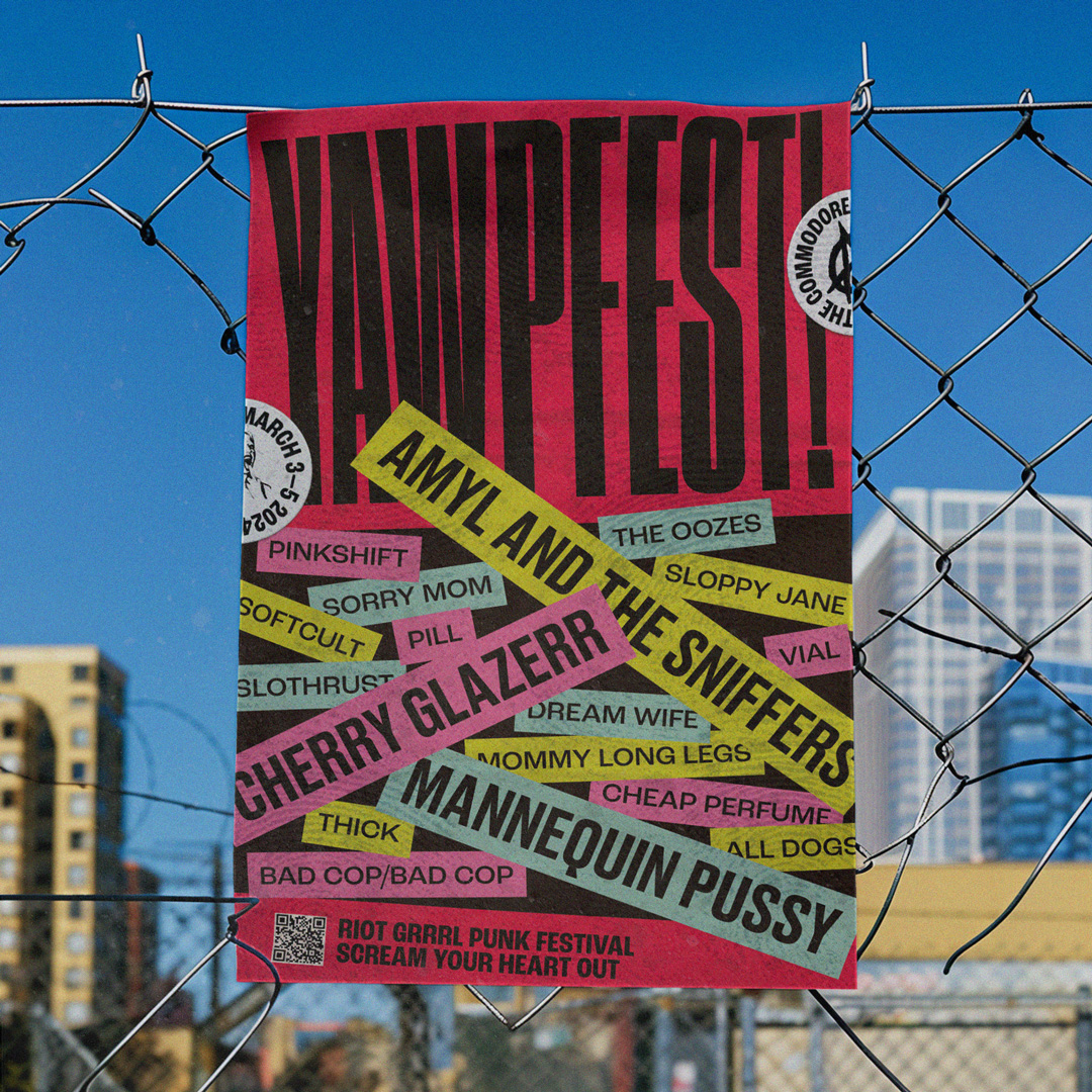 Yawpfest!’s colourful, riot grrrl-inspired poster pinned to a chain-link fence against a blue sky.
